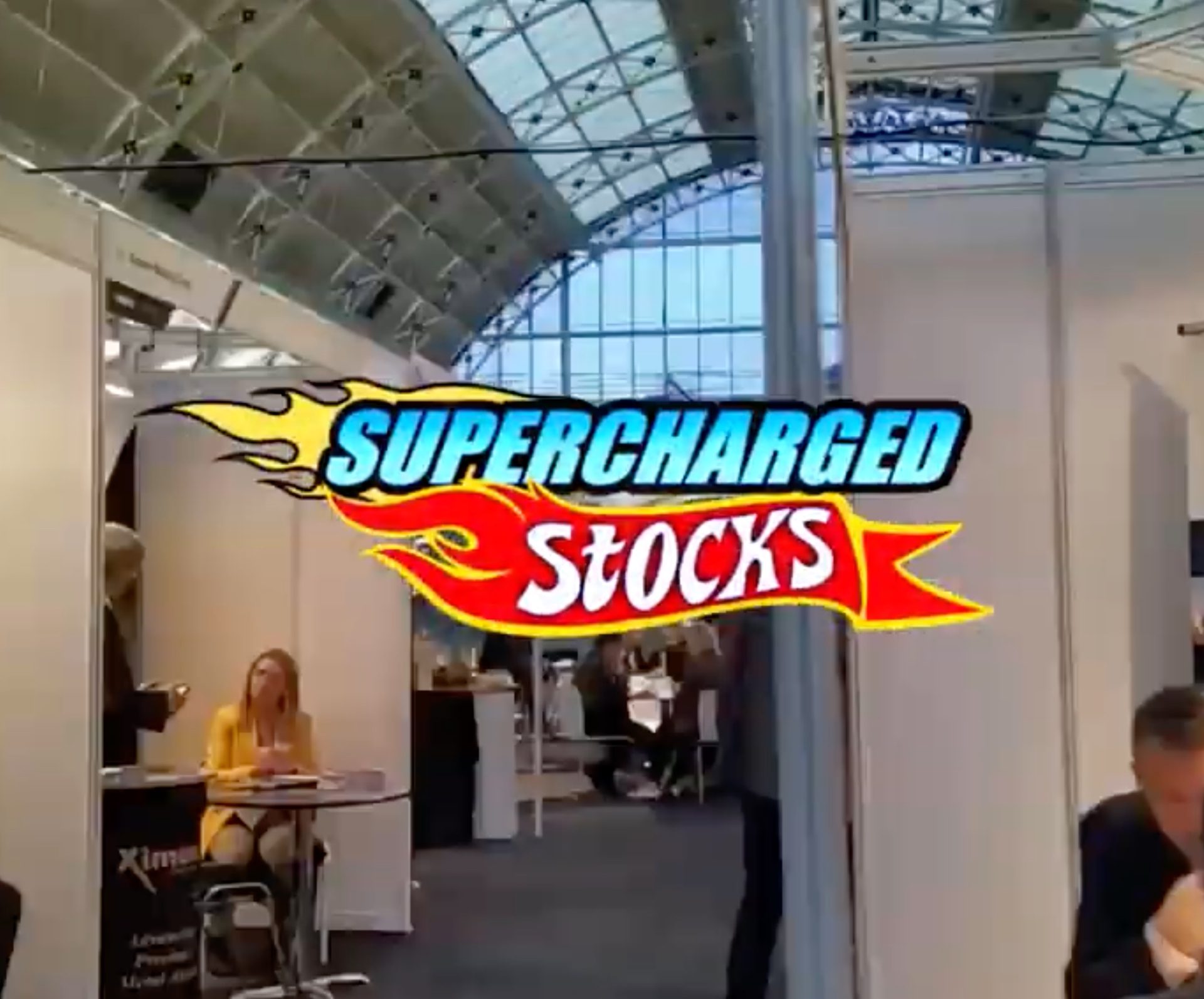 Supercharged Stocks logo on photo of conference